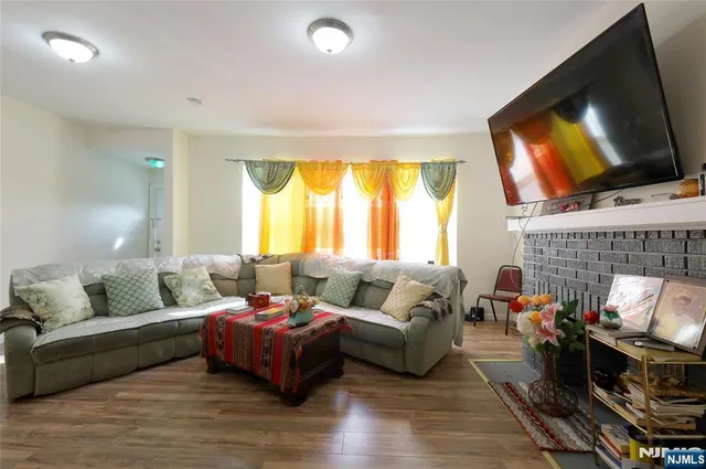 a living room with furniture fireplace and a flat screen tv