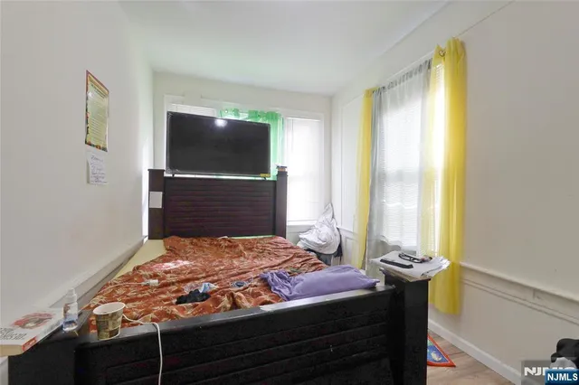 a bedroom with a bed and flat screen tv