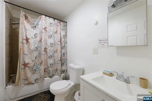 a bathroom with a sink toilet and a mirror