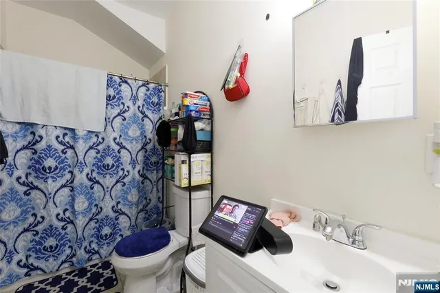a bathroom with a sink toilet and a mirror