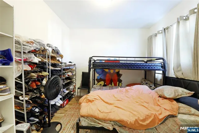 a bed sitting in a bedroom next to a window