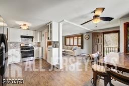 181 East Pleasant Grove Road Jackson, NJ 08527 - Photo 7 of 27 a open kitchen with stainless steel appliances granite countertop a stove refrigerator and a dining table with wooden floor