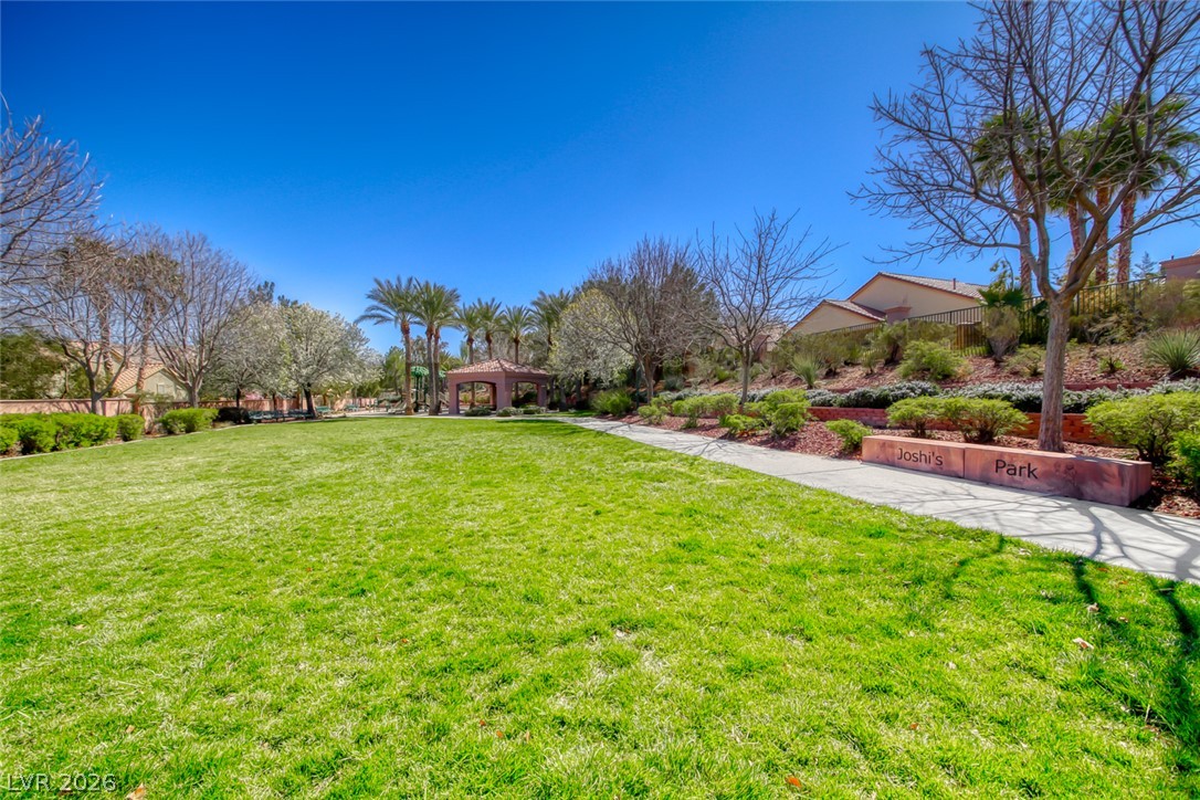 2122 Mooreview Street Henderson, NV 89012 - Photo 43 of 44 Green lawns and paved walkways define this community park, offering a peaceful retreat amidst lush landscaping.
