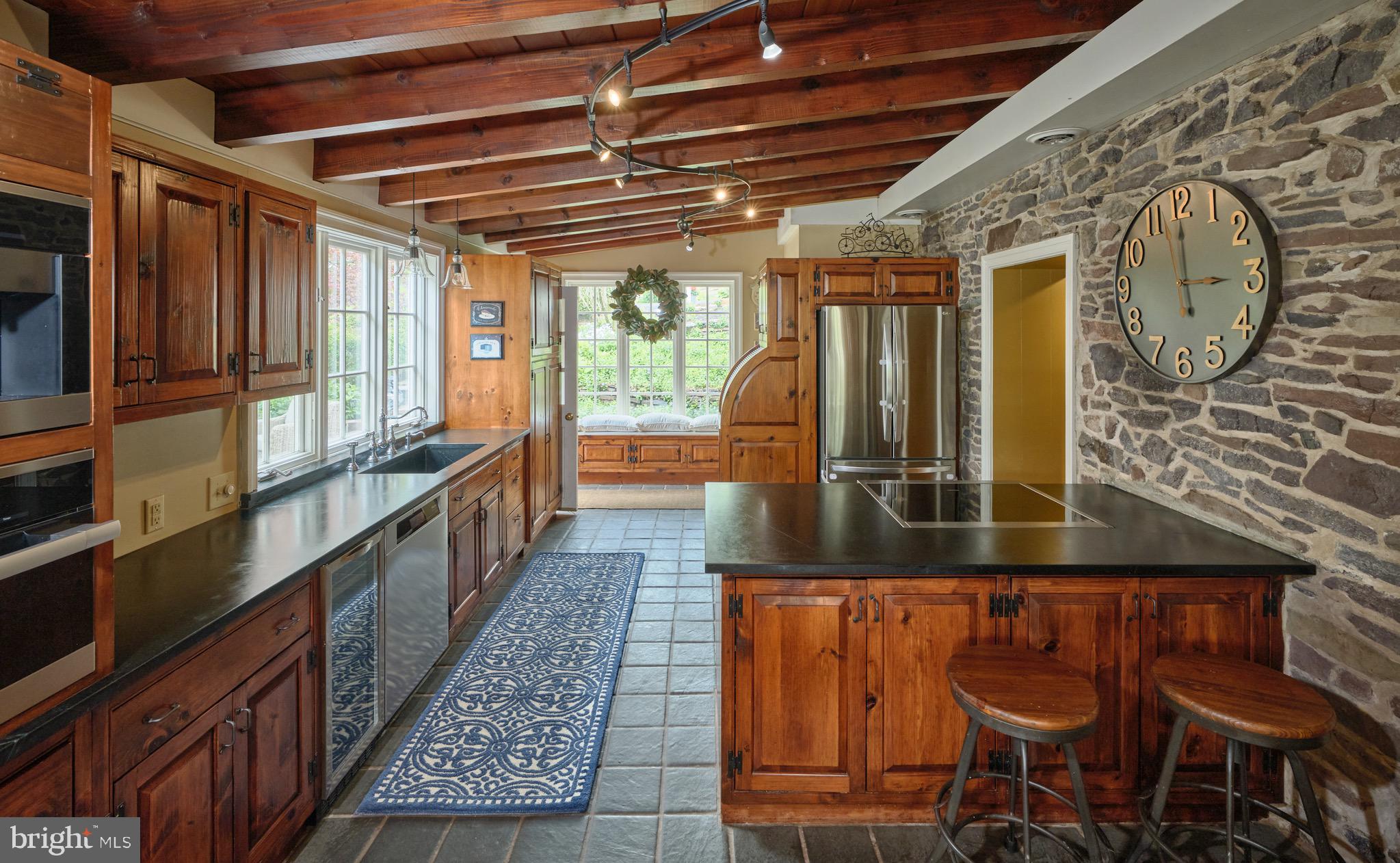 2135 South Sugan Road New Hope, PA 18938 - Photo 8 of 46 Kitchen with exposed beams and stone