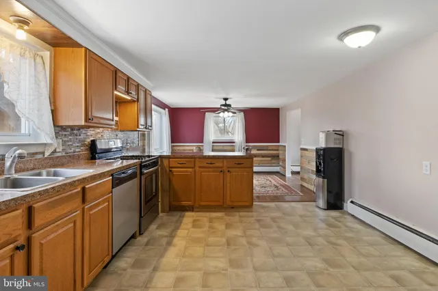 a kitchen with stainless steel appliances granite countertop a stove sink and cabinets