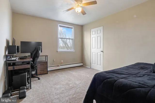 a living room with a bed furniture and a flat screen tv