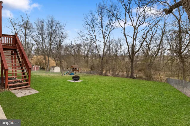 a view of backyard with table and chairs and potted plants