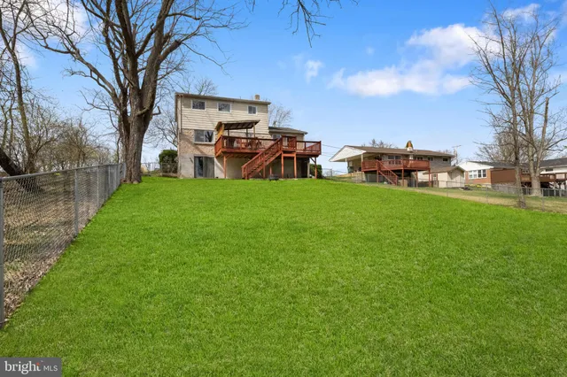 an aerial view of a house with a yard and lake view