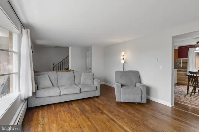 a living room with furniture and a lamp
