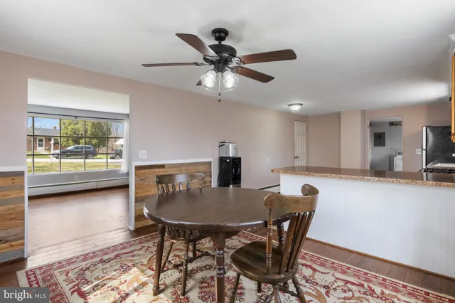 a dining room with furniture and window