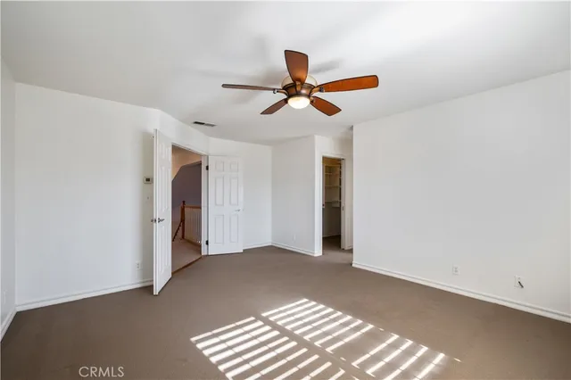 a view of empty room with ceiling fan
