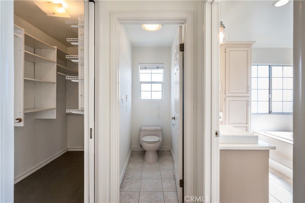 5306 Halison Street Torrance, CA 90503 - Photo 27 of 38 a bathroom with a granite countertop toilet a sink and a large mirror