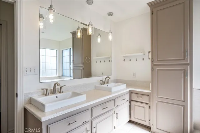 a bathroom with a sink double vanity and a mirror