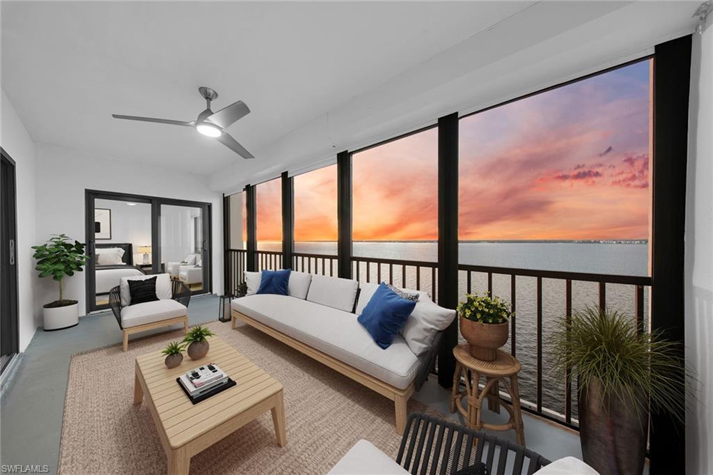 a living room with furniture and floor to ceiling windows