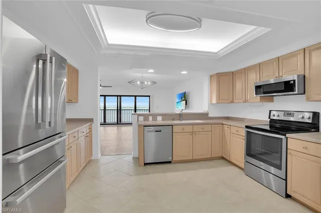 a kitchen with granite countertop a stove sink and microwave