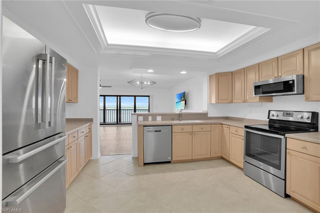 1925 Clifford Street, Unit 1102 Fort Myers, FL 33901 - Photo 11 of 50 a kitchen with granite countertop a stove sink and microwave