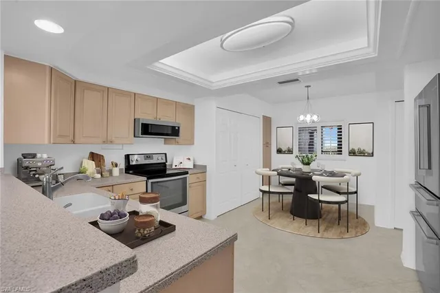 a kitchen with a sink a stove and white cabinets