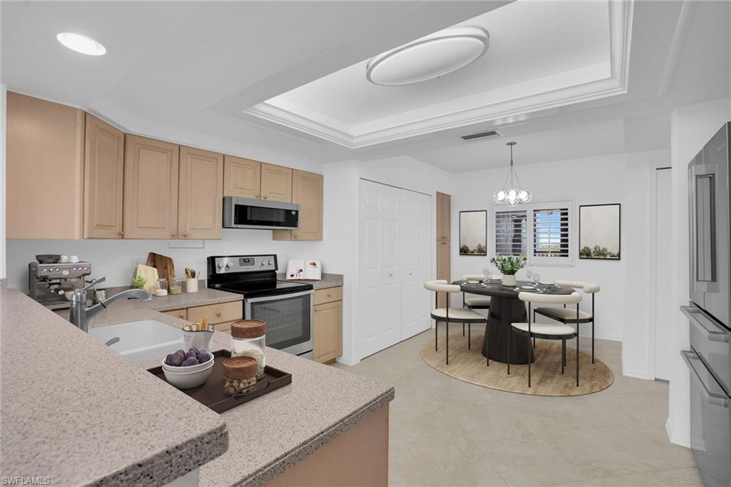 1925 Clifford Street, Unit 1102 Fort Myers, FL 33901 - Photo 12 of 50 a kitchen with a sink a stove and white cabinets