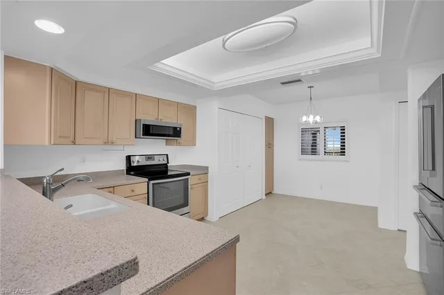 a kitchen that has a sink and a stove top oven