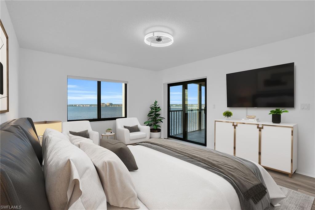 1925 Clifford Street, Unit 1102 Fort Myers, FL 33901 - Photo 16 of 50 a bedroom with a bed and a flat screen tv