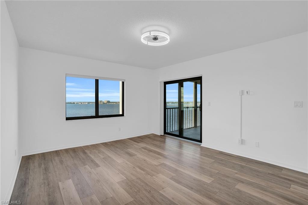 1925 Clifford Street, Unit 1102 Fort Myers, FL 33901 - Photo 17 of 50 a view of an empty room with wooden floor and a window