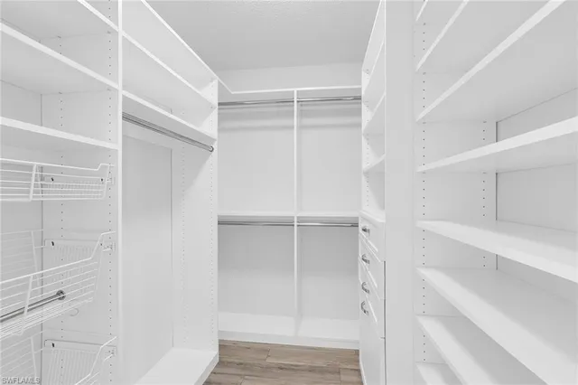 a view of walk in closet with empty racks
