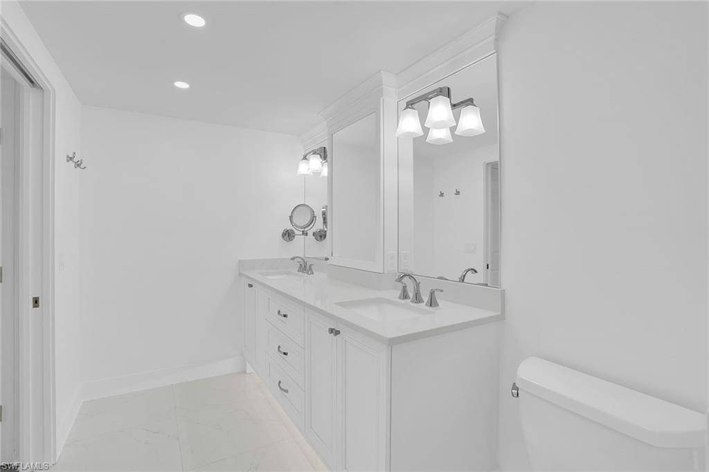 1925 Clifford Street, Unit 1102 Fort Myers, FL 33901 - Photo 21 of 50 a bathroom with a sink mirror and toilet