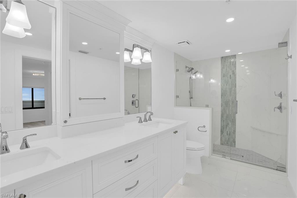 1925 Clifford Street, Unit 1102 Fort Myers, FL 33901 - Photo 22 of 50 a spacious bathroom with a double vanity sink mirror and shower