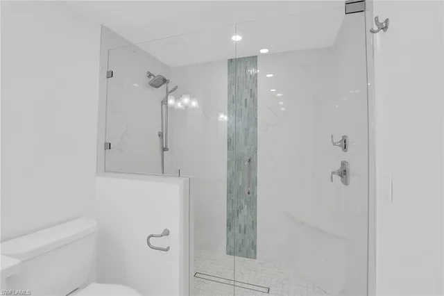 a bathroom with a shower a toilet and sink