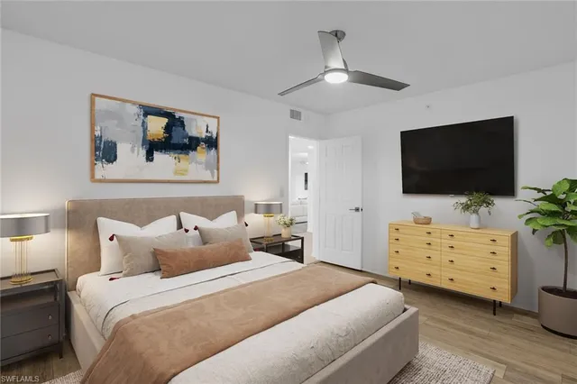 a bedroom with a bed and a flat screen tv