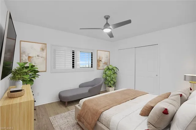 a bedroom with a bed and a potted plant