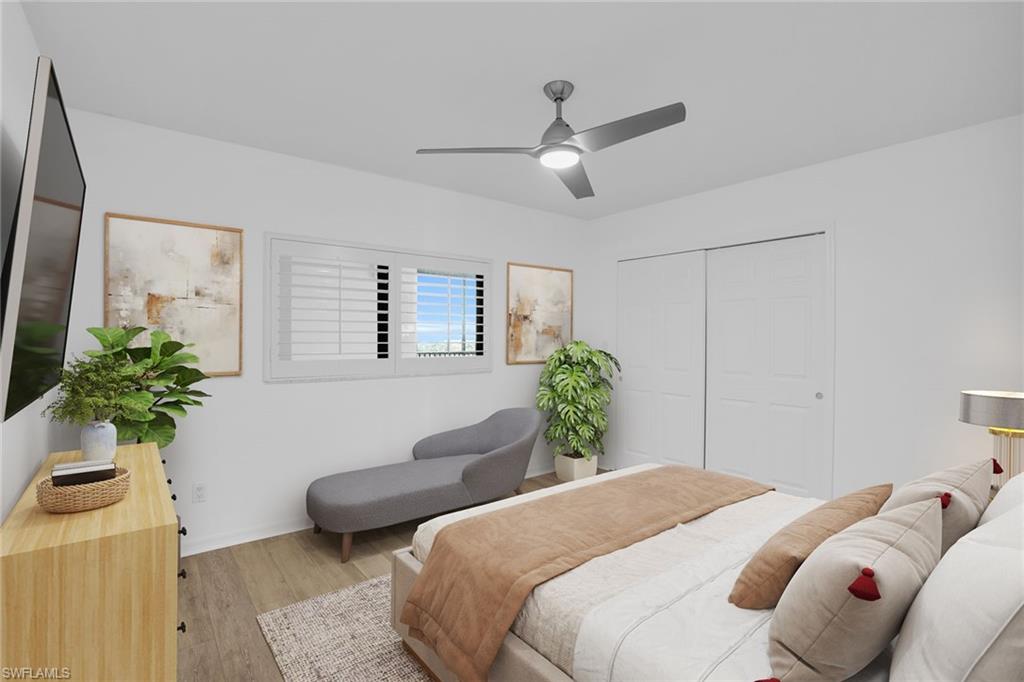 1925 Clifford Street, Unit 1102 Fort Myers, FL 33901 - Photo 26 of 50 a bedroom with a bed and a potted plant