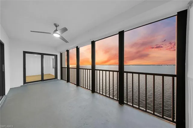 a view of a big room with windows ceiling fan and windows