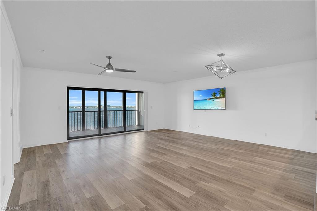 1925 Clifford Street, Unit 1102 Fort Myers, FL 33901 - Photo 4 of 50 wooden floor in an empty room with a window