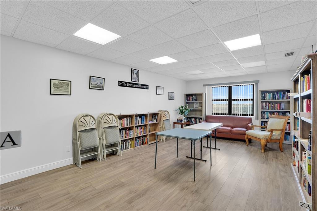 1925 Clifford Street, Unit 1102 Fort Myers, FL 33901 - Photo 44 of 50 a living room with furniture and a book shelf