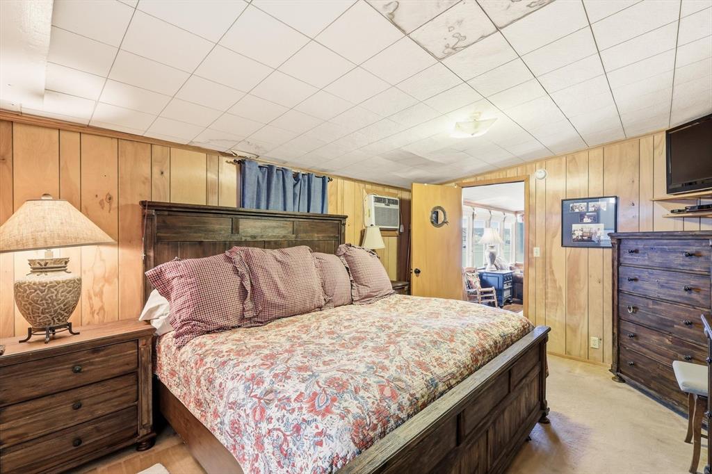 4513 Chapel Road Graham, TX 76450 - Photo 18 of 38 a bedroom with a large bed and a flat tv screen tv
