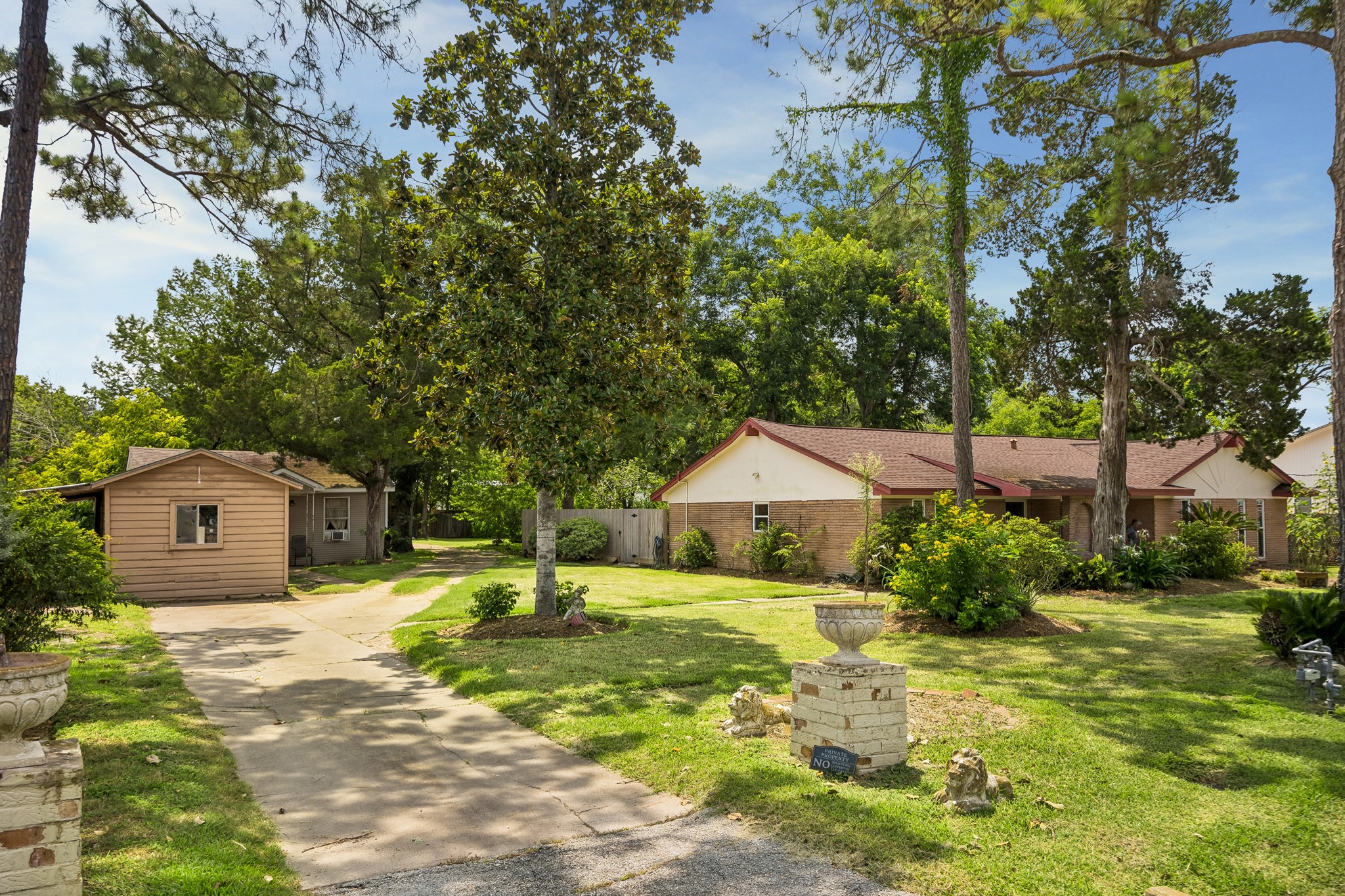 413 Mebane Lane Rosenberg, TX 77471 - Photo 6 of 30 This charming single-story home shares a driveway with a carport, storage building and a smaller home. The mature trees and large yard make this a very serene and inviting atmosphere.