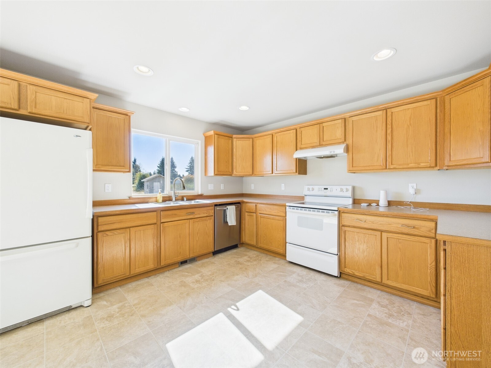 7143 196th Avenue Southwest Rochester, WA 98579 - Photo 12 of 34 a large kitchen with granite countertop a sink stainless steel appliances and cabinets