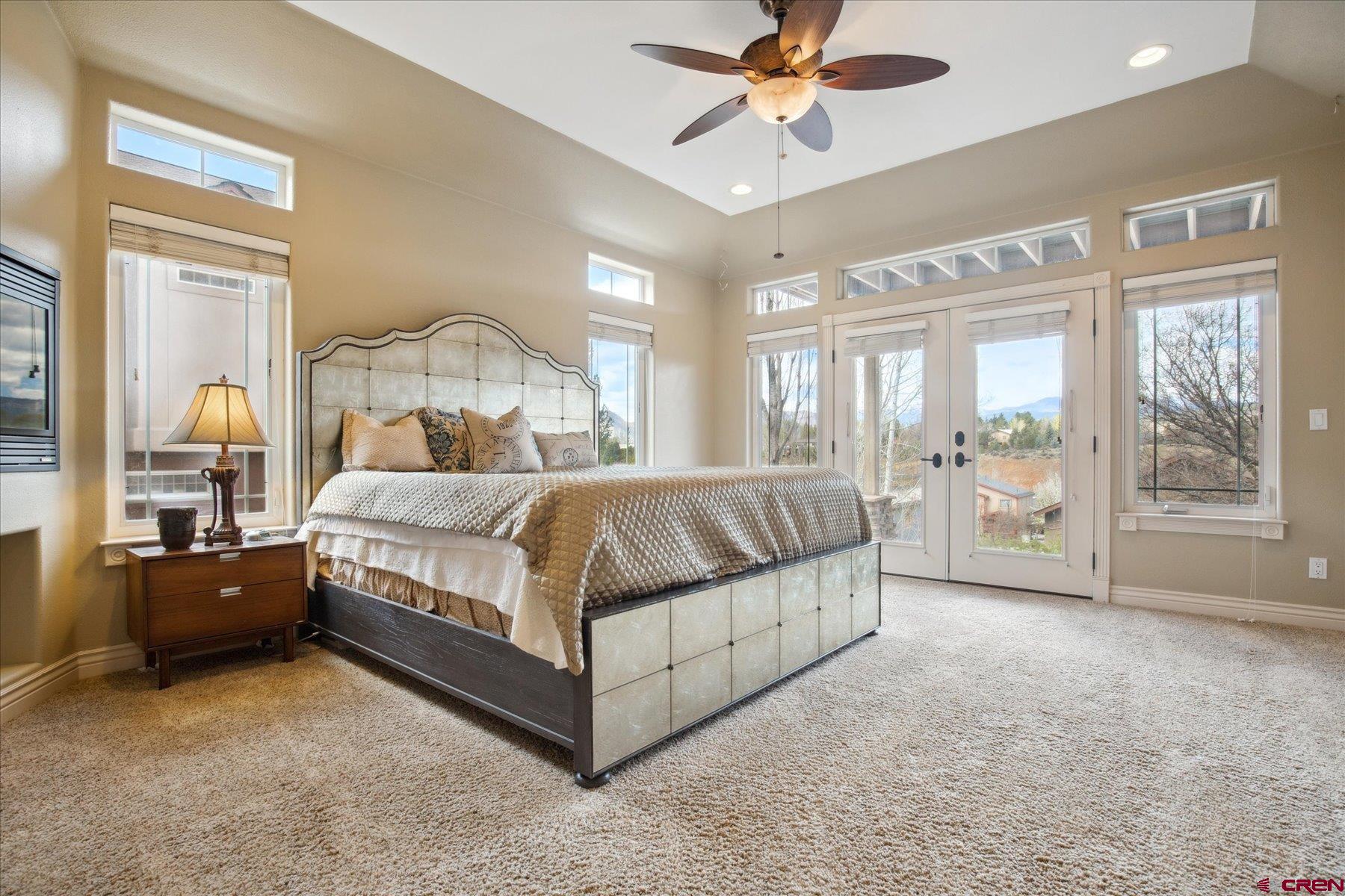 39 Ophir Drive Durango, CO 81301 - Photo 26 of 44 a bedroom with a large bed and a chandelier fan