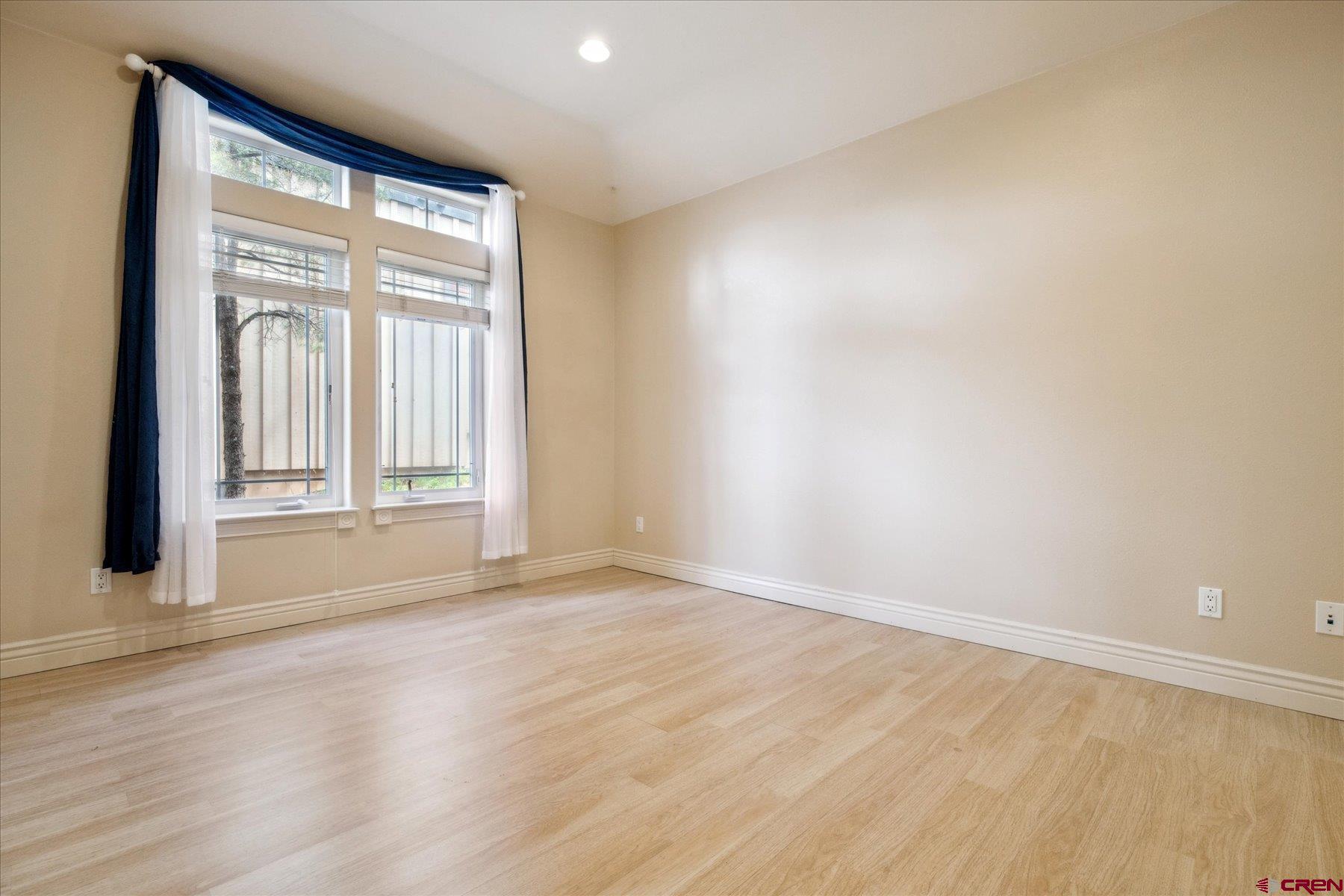 39 Ophir Drive Durango, CO 81301 - Photo 34 of 44 an empty room with wooden floor and windows