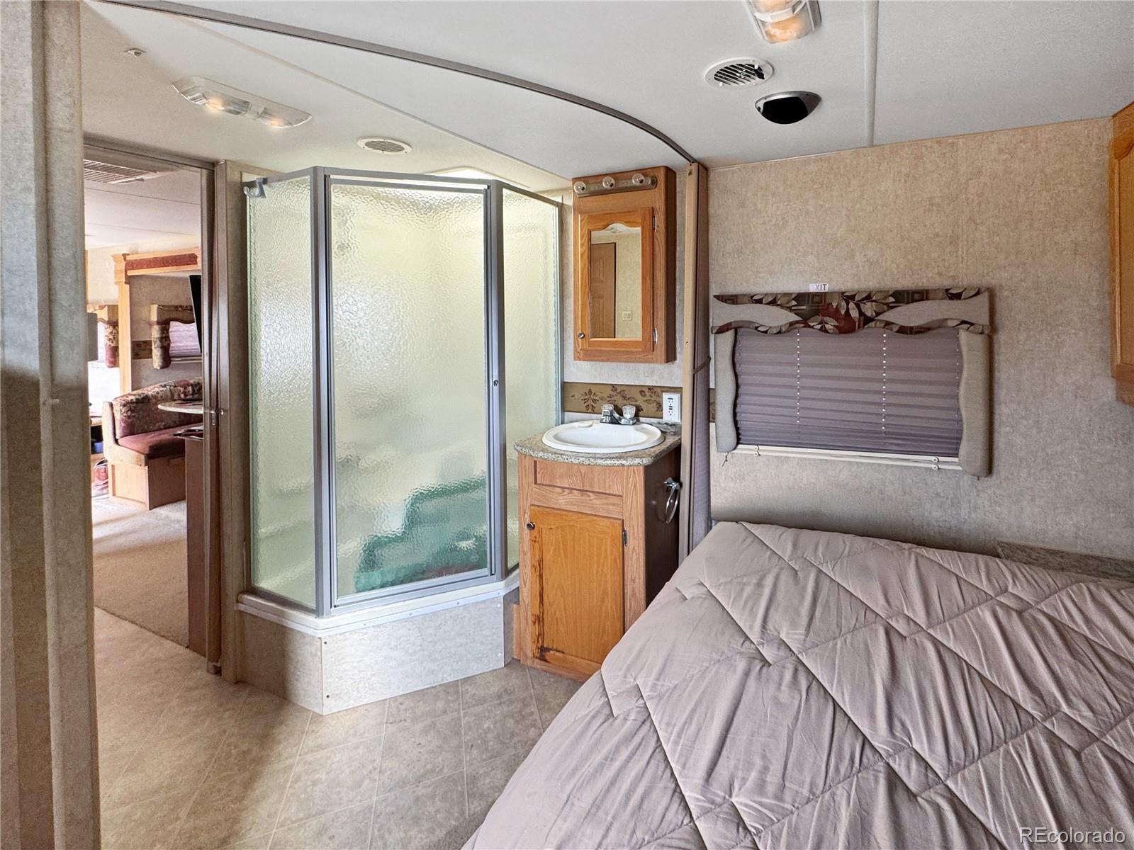 1525 L Path Cotopaxi, CO 81223 - Photo 12 of 28 a bedroom with a bed and a mirror