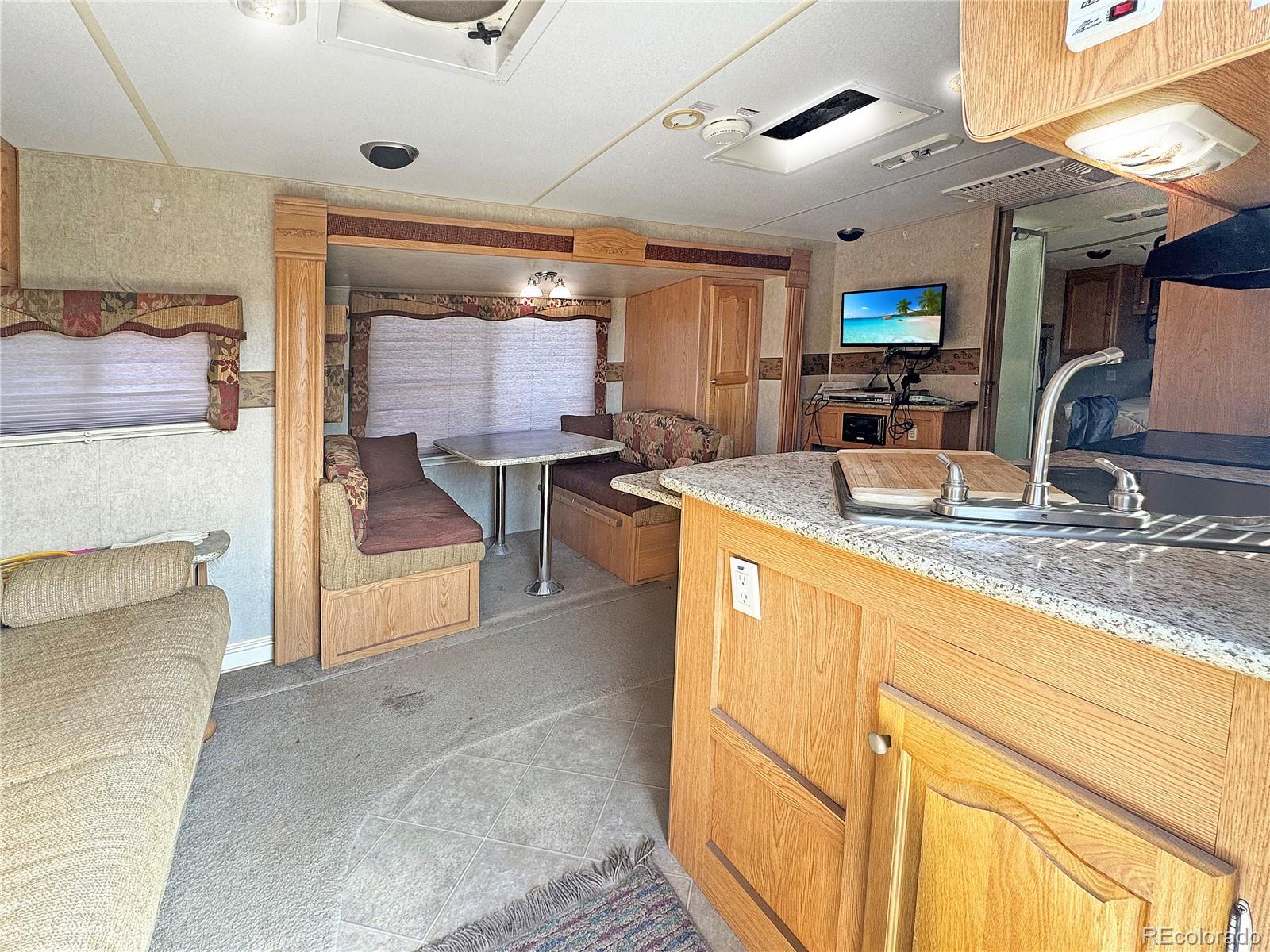 1525 L Path Cotopaxi, CO 81223 - Photo 9 of 28 a kitchen with stainless steel appliances granite countertop a sink stove and cabinets