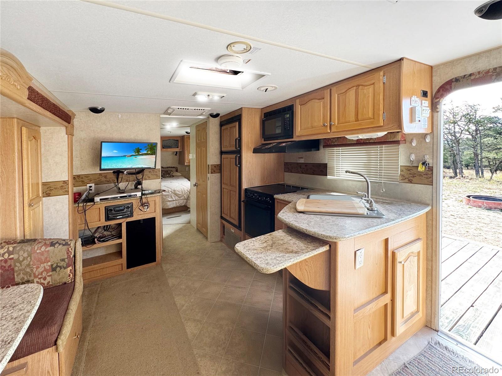 1525 L Path Cotopaxi, CO 81223 - Photo 10 of 28 a kitchen with stainless steel appliances kitchen island granite countertop a sink and cabinets
