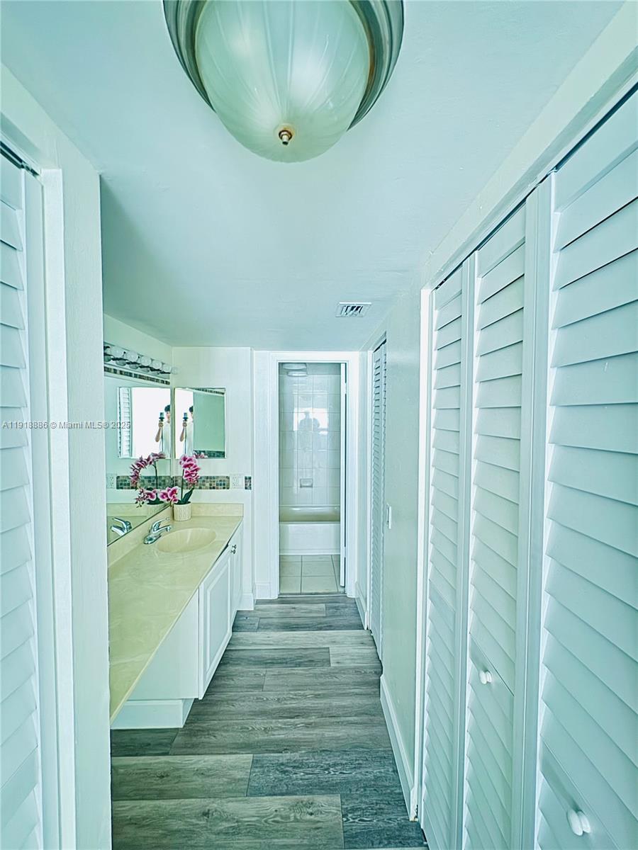 701 North Pine Island Road, Unit 101 Plantation, FL 33324 - Photo 12 of 31 a bathroom with a sink and mirror