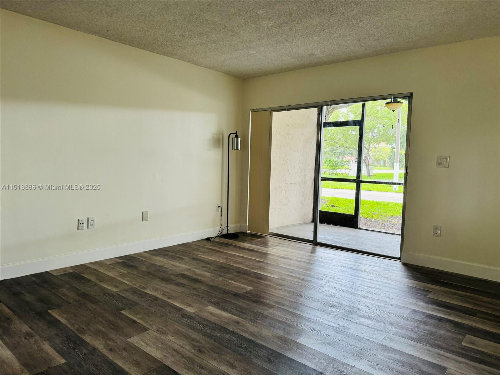 701 North Pine Island Road, Unit 101 Plantation, FL 33324 - Photo 13 of 31 a view of an empty room with wooden floor and a window