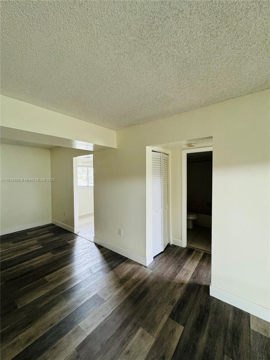 701 North Pine Island Road, Unit 101 Plantation, FL 33324 - Photo 15 of 31 an empty room with wooden floor and closet