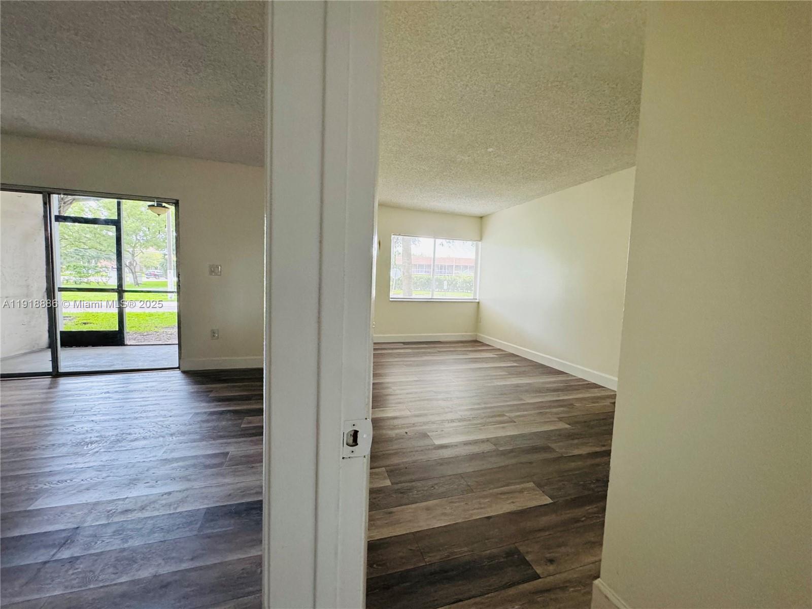 701 North Pine Island Road, Unit 101 Plantation, FL 33324 - Photo 22 of 31 a view of empty room with wooden floor and fan