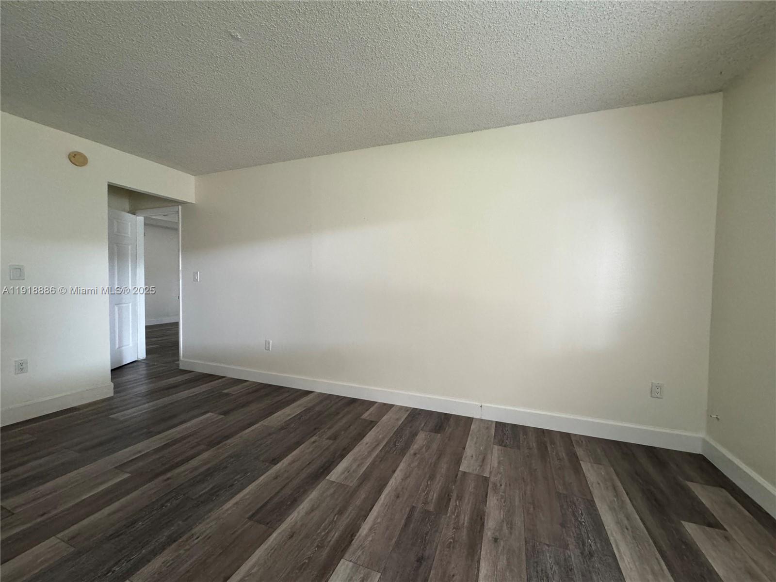 701 North Pine Island Road, Unit 101 Plantation, FL 33324 - Photo 24 of 31 a view of an empty room with wooden floor