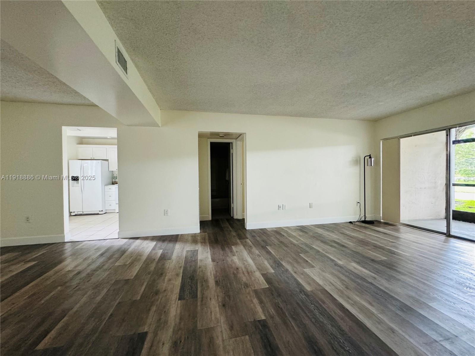 701 North Pine Island Road, Unit 101 Plantation, FL 33324 - Photo 25 of 31 an empty room with wooden floor & closet and windows