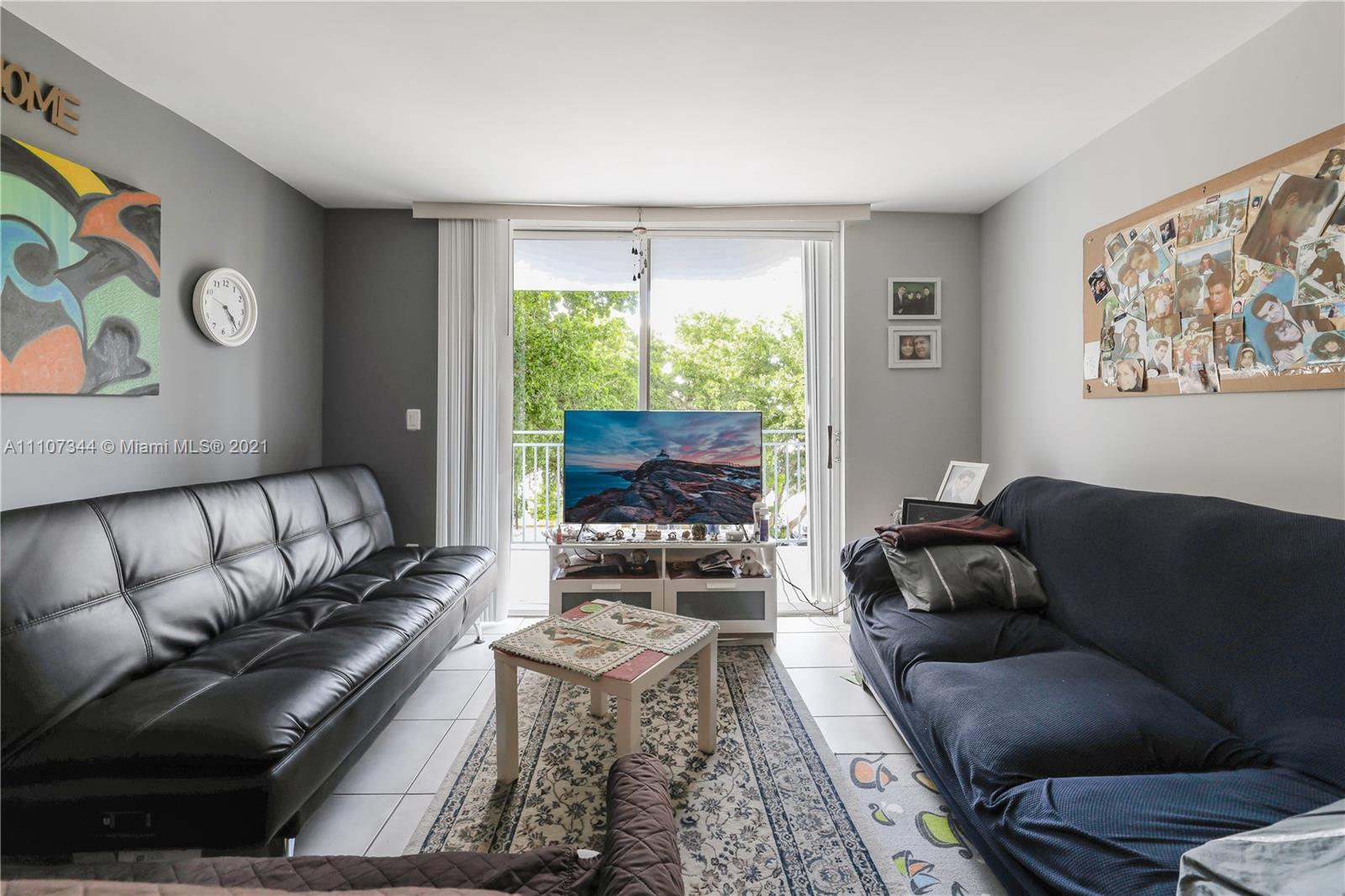 750 Northeast 64th Street, Unit B415 Miami, FL 33138 - Photo 2 of 32 a living room with furniture and a large window